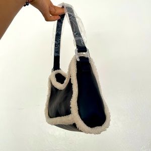 Black leather-like Poster Girl purse with white fur trim